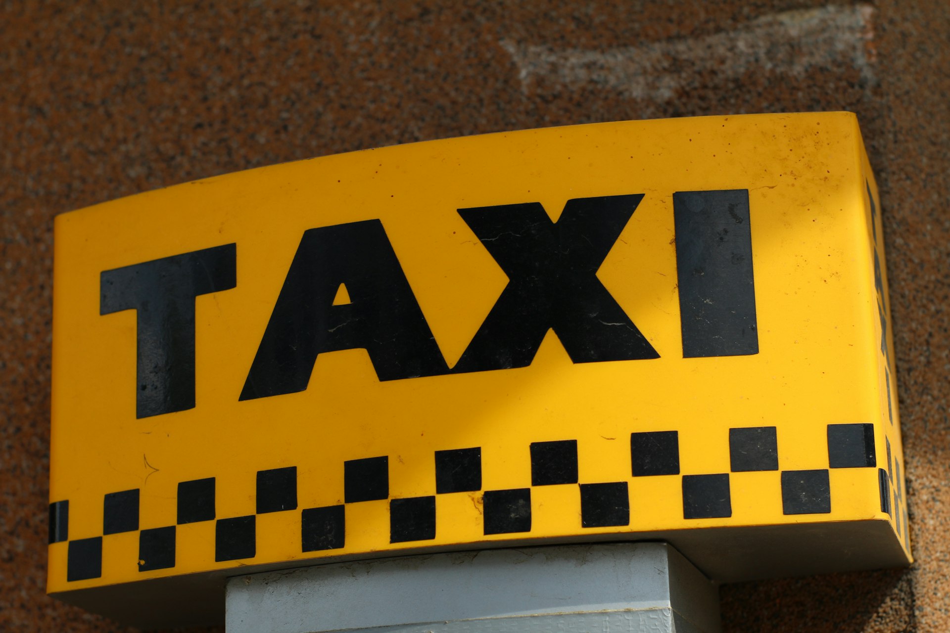 a close up of a taxi sign on a building